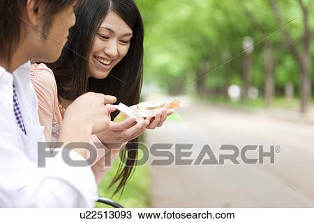 Young man proposing to girlfriend in a park View Large Photo Image Stock Image - Young man proposing to girlfriend in a park. Fotosearch