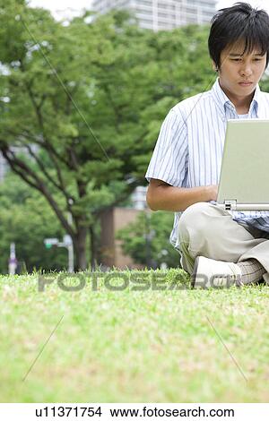 Picture - Young Man Using Laptop. Fotosearch