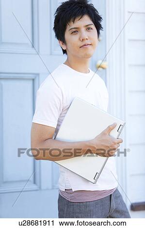 Stock Image - Young Man with Laptop. Fotosearch