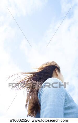 Stock Photograph - Young Woman Against Sky. Fotosearch