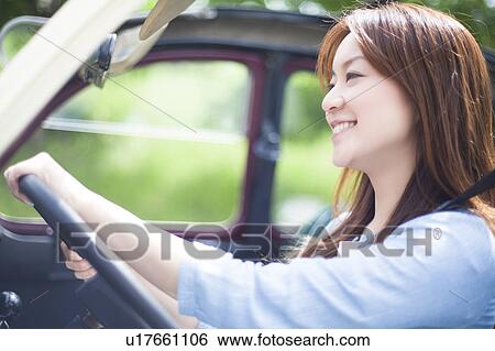 Stock Photograph - Young Woman Driving Covertible. Fotosearch
