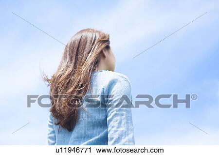 Stock Image - Young Woman Enjoying Herself Outdoors. Fotosearch