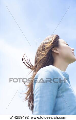 Stock Image - Young Woman Enjoying Herself Outdoors. Fotosearch
