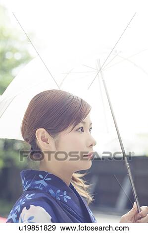 Stock Photo - Young Woman in Kimono Under Umbrella. Fotosearch