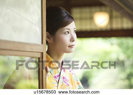 Stock Image - Young Woman in Yukata Looking at View. Fotosearch