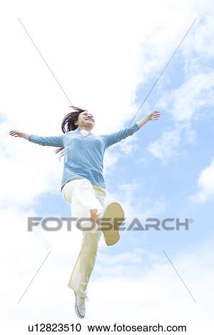 Young Woman Jumping, Low Angle View View Large Photo Image Stock Image - Young Woman Jumping, Low Angle View. Fotosearch