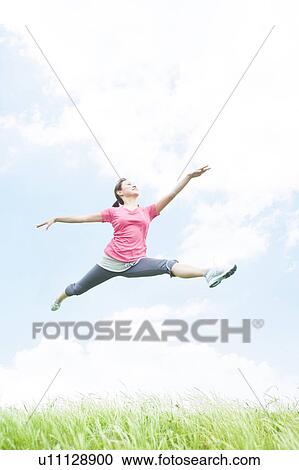 Stock Image - Young Woman Jumping. Fotosearch