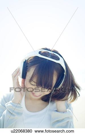 Young Woman Listening to Headphones View Large Photo Image Stock Image - Young Woman Listening to Headphones. Fotosearch