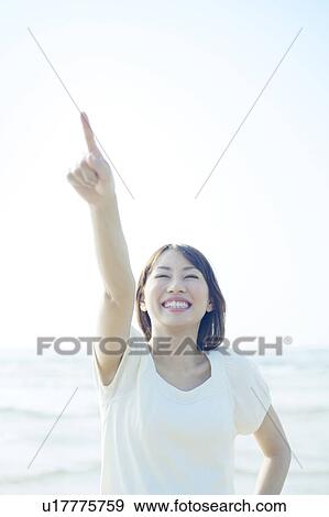 Young Woman Pointing to Sky View Large Photo Image Stock Photo - Young Woman Pointing to Sky. Fotosearch