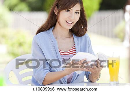 Stock Photograph - Young Woman Reading Book. Fotosearch