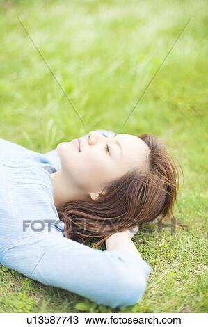 Young Woman Relaxing on Grass View Large Photo Image Stock Image - Young Woman Relaxing on Grass. Fotosearch