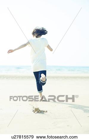 Stock Photo - Young Woman Running on Beach. Fotosearch