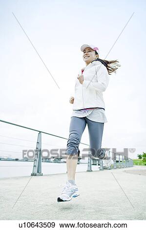 Stock Photo - Young Woman Running. Fotosearch