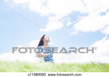Young Woman Sitting on Tall Grass View Large Photo Image Stock Image - Young Woman Sitting on Tall Grass. Fotosearch