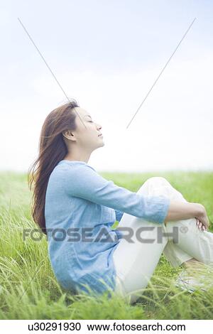 Young Woman Sitting on Tall Grass View Large Photo Image Stock Image - Young Woman Sitting on Tall Grass. Fotosearch