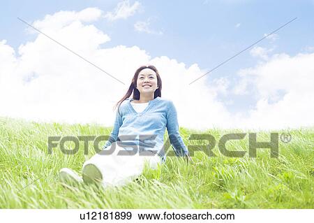 Young Woman Sitting on Tall Grass View Large Photo Image Stock Photo - Young Woman Sitting on Tall Grass. Fotosearch