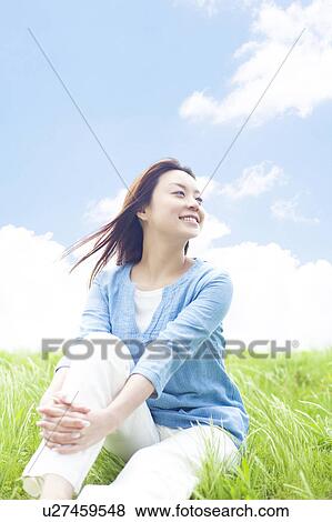 Young Woman Sitting on Tall Grass View Large Photo Image Stock Photo - Young Woman Sitting on Tall Grass. Fotosearch