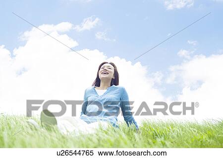 Young Woman Sitting on Tall Grass View Large Photo Image Stock Photography - Young Woman Sitting on Tall Grass. Fotosearch