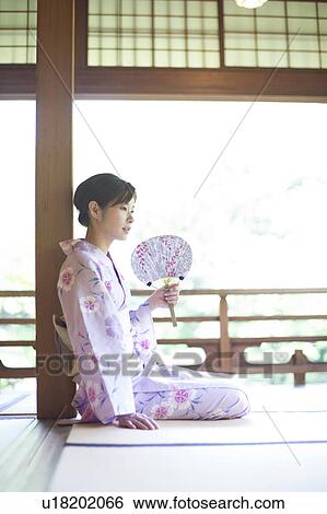 Stock Photograph - Young Woman Sitting on Tatami. Fotosearch
