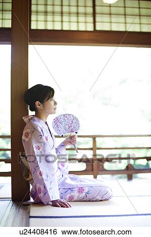 Stock Photograph - Young Woman Sitting on Tatami. Fotosearch