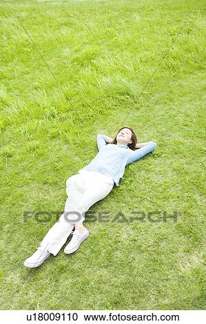Young Woman Sleeping on Grass View Large Photo Image Stock Image - Young Woman Sleeping on Grass. Fotosearch