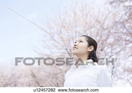 Stock Image - Young woman standing. Fotosearch