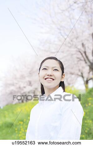 Stock Image - Young woman standing. Fotosearch