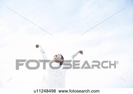Stock Photo - Young woman stretching arms. Fotosearch