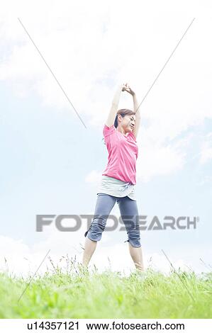 Young Woman Stretching on Grass View Large Photo Image Stock Image - Young Woman Stretching on Grass. Fotosearch