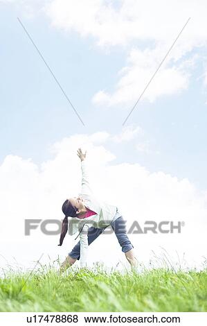 Young Woman Stretching on Grass View Large Photo Image Stock Photo - Young Woman Stretching on Grass. Fotosearch