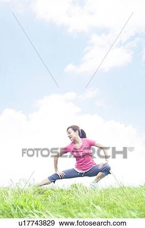 Young Woman Stretching on Grass View Large Photo Image Stock Photo - Young Woman Stretching on Grass. Fotosearch