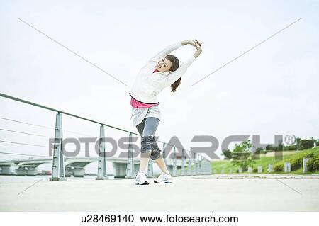 Stock Image - Young Woman Stretching. Fotosearch