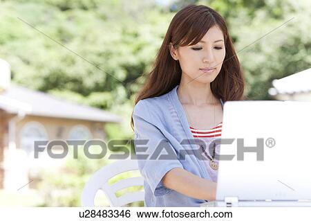 Young Woman Using Laptop in Garden View Large Photo Image Stock Photograph - Young Woman Using Laptop in Garden. Fotosearch