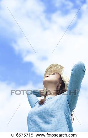 Young Woman Wearing Hat and Looking Up At Sky View Large Photo Image Stock Photography - Young Woman Wearing Hat and Looking Up At Sky. Fotosearch