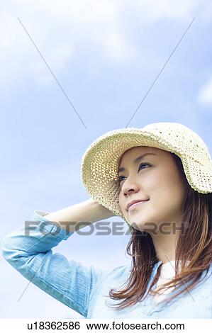 Stock Photograph - Young Woman Wearing Hat. Fotosearch