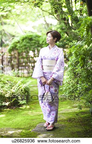 Stock Photograph - Young Woman Wearing Yukata in Garden. Fotosearch