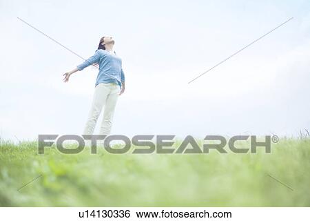 Stock Photograph - Young Woman with Arms Outstretched. Fotosearch