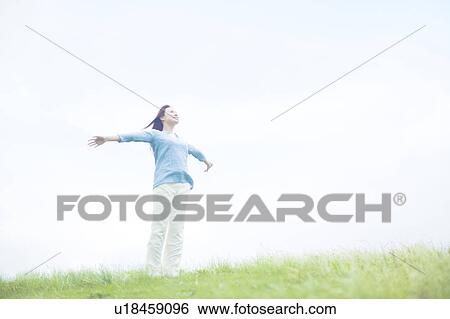 Stock Photograph - Young Woman with Arms Outstretched. Fotosearch