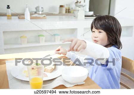 A boy having a meal View Large Photo Image Picture - A boy having a meal. Fotosearch