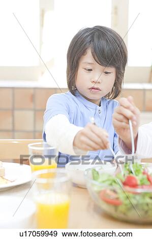 A boy having a meal View Large Photo Image Stock Photo - A boy having a meal. Fotosearch