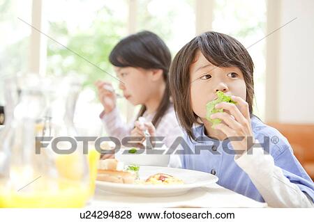 Stock Photo - A boy having a meal. Fotosearch