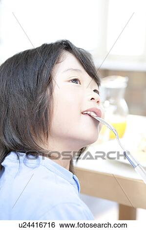 Stock Photograph - A boy having a meal. Fotosearch