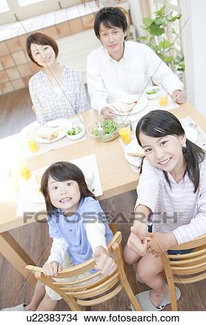 Picture - A family having a meal. Fotosearch