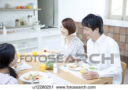 Stock Image - A family having a meal. Fotosearch