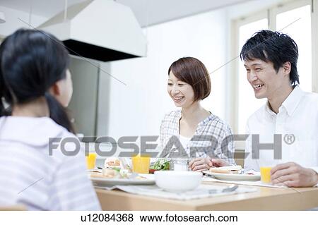 Stock Photo - A family having a meal. Fotosearch