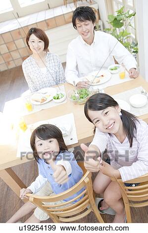 A family having a meal View Large Photo Image Stock Photo - A family having a meal. Fotosearch