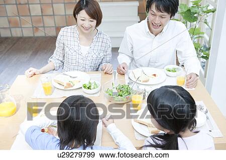 A family having a meal View Large Photo Image Stock Photo - A family having a meal. Fotosearch