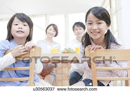 A family having a meal View Large Photo Image Stock Photo - A family having a meal. Fotosearch
