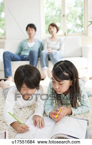 A family in the living room View Large Photo Image Picture - A family in the living room. Fotosearch