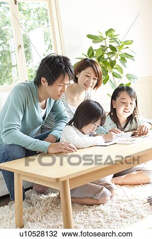 A family in the living room View Large Photo Image Stock Image - A family in the living room. Fotosearch